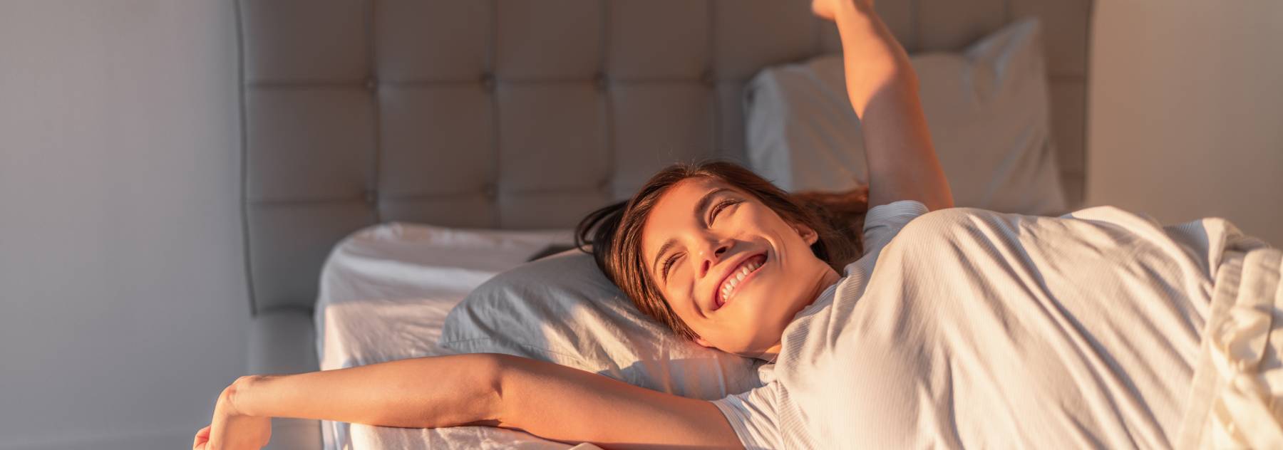 Happy girl waking up after a good night sleep