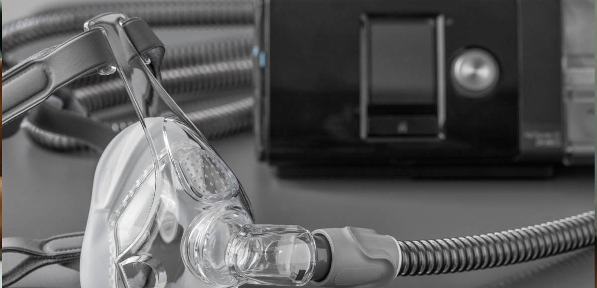 CPAP machine cleaning supplies and mask on a clean surface